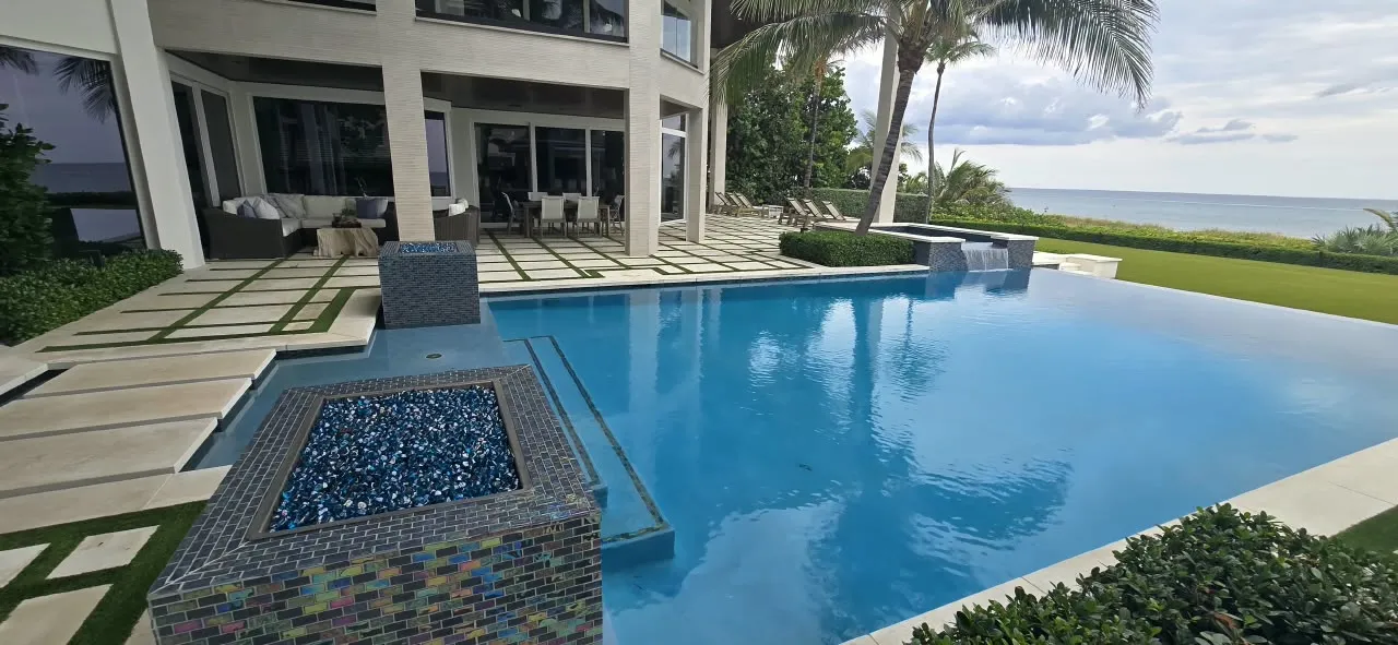 Oceanfront infinity pool with large-format paver decking