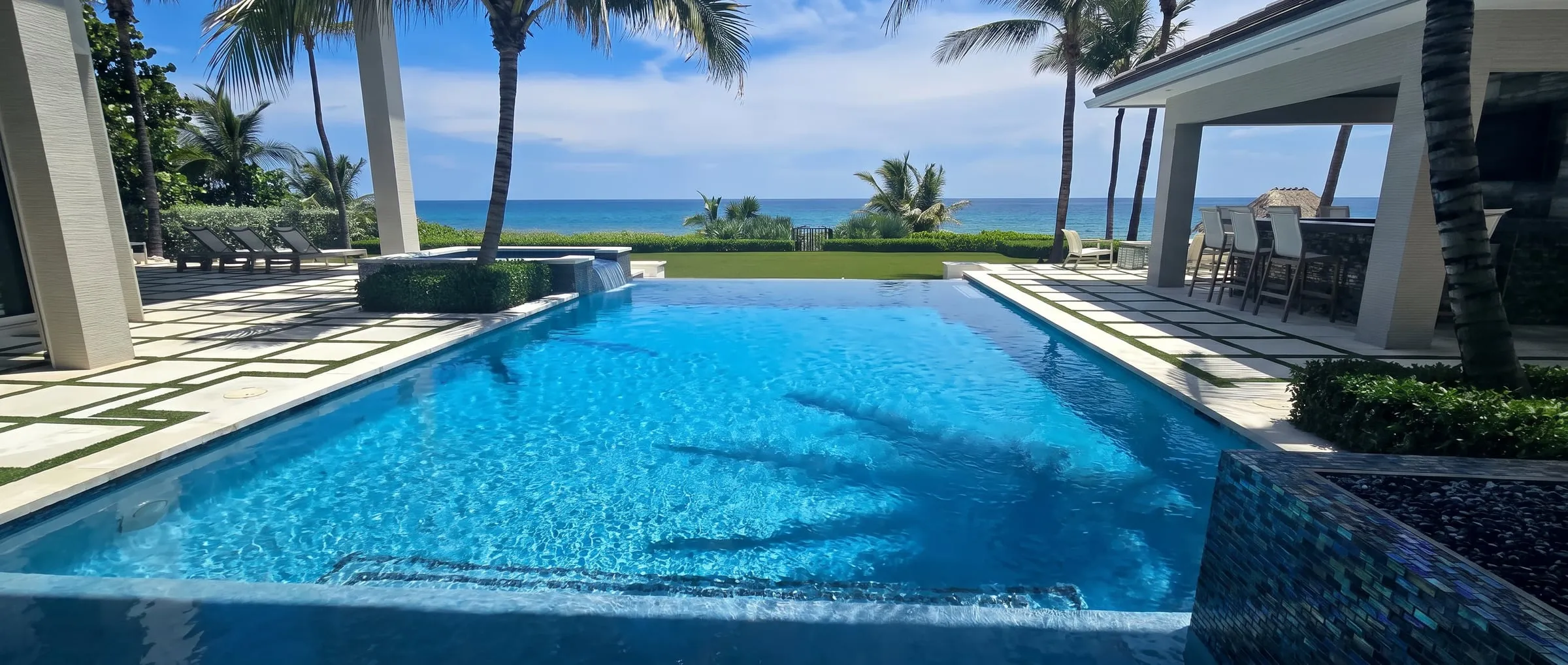 Oceanfront paver patio with a checkerboard paver and turf pattern