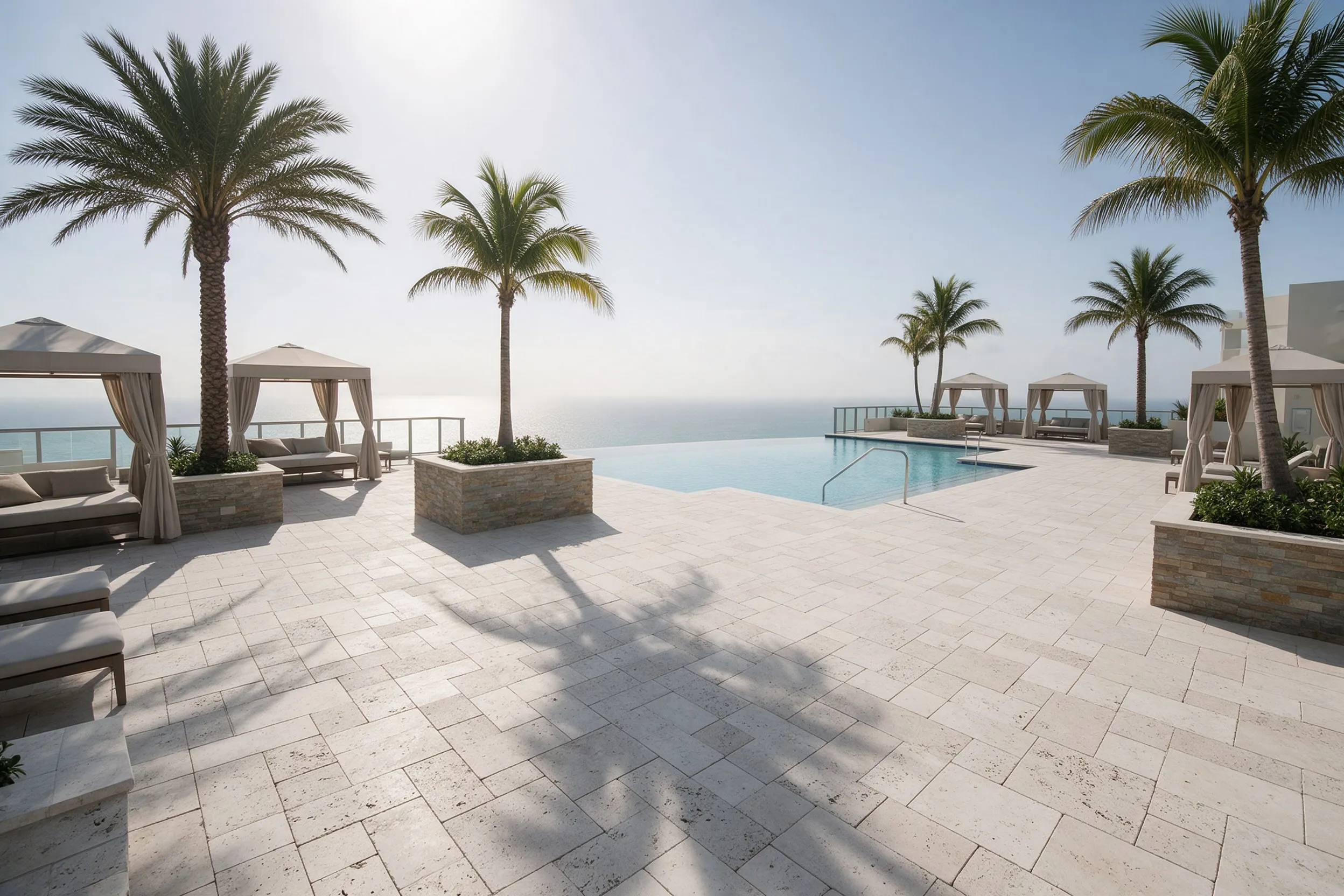 Condominium pool deck with travertine-look pavers and cabanas